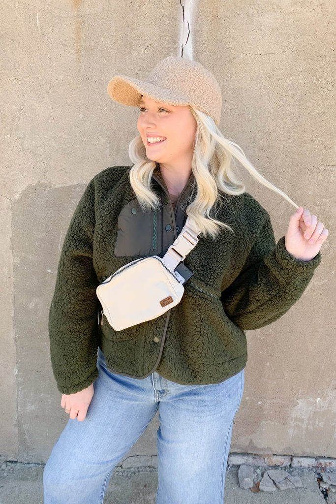 The Creek Fleece Button Front Jacket is so soft and elevated. You can choose between a classic ivory color that goes with everything, or add pop of color to your look with olive. Either way, both colors are so fun for fall! This sherpa fleece jacket has full snap buttons along the front, and two zippered breast pockets. It's an easy layering piece for on the go. 