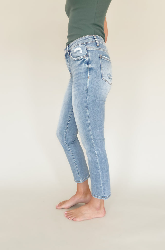 Light wash mid rise straight leg jeans with slight distressing around the pockets. 