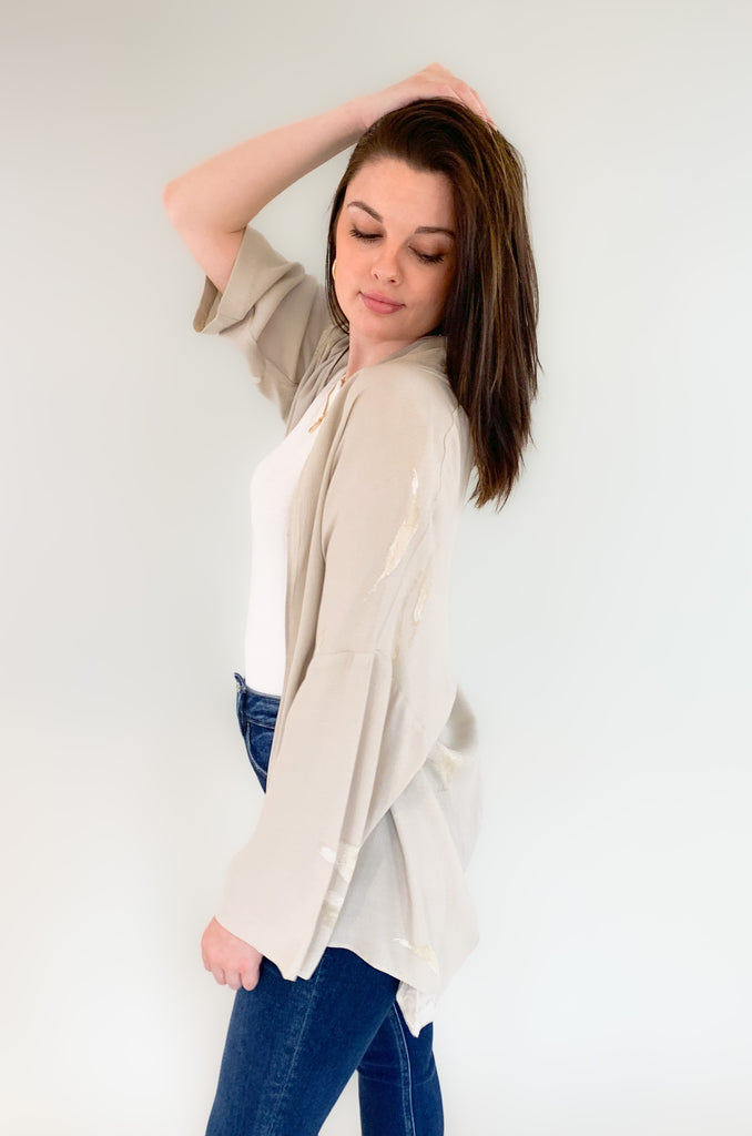 The Wisp Loose Fit Relaxed Cardigan is elevated and stylish for so many occasions! It's nice to have a go-to layering piece for dresses, tanks, or anything sleeveless. This style has a nice lightweight fabric and a gorgeous golden abstract print. It's a must-have addition to any fashion-forward wardrobe. 